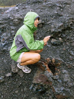 In a drizzling rain, Nohe, a guide lectures cruise ship passengers about a lava field