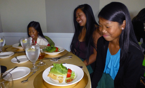 Sisters, from left, Meilani, Michelle, and Alyssa Molina admire the salad presentation