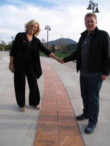 Pastor Jim and Rosemary Garlow along walkway honoring biblical personages