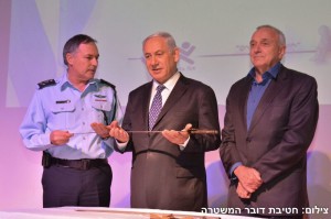 Jabotinsky's sword is presented to Prime Minister Benjamin Netanyahu by Police CommissionerYochanan Danino, as Minister of Internal Security Yitzhak Aharanovitch, at right, attends