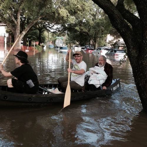 The iconic photo of Morgan Davies (far left) and Donniel Ogorek (center) rescuing Rabbi Joseph Radinsky (right) from the flood in Houston. Credit: Robert Levy via Facebook.