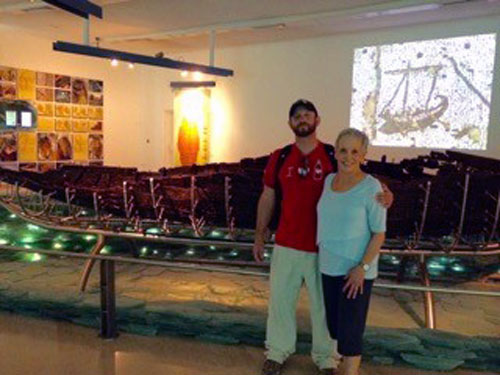 Moshe Kramer and mother Michal pose alongside the 2000 year old "Jesus boat"